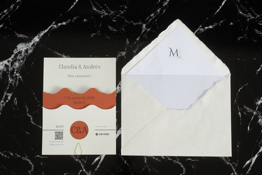 Invitación de boda Jade en color terracota con diseño ondulado en papel natural de alta calidad, acompañada de sobre artesanal hecho a mano con forro blanco.